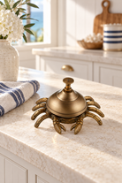 Brass crab table bell styled in a coastal kitchen