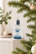Gin Bottle Glass Tree Ornament - Blue styled indoors with pale whitewashed furniture and summer light; Coast to Coast XX10344