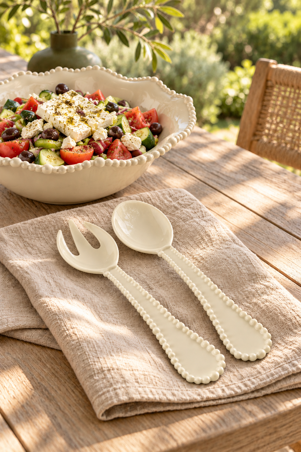 Sand Pearl salad servers with rustic Greek salad outdoors