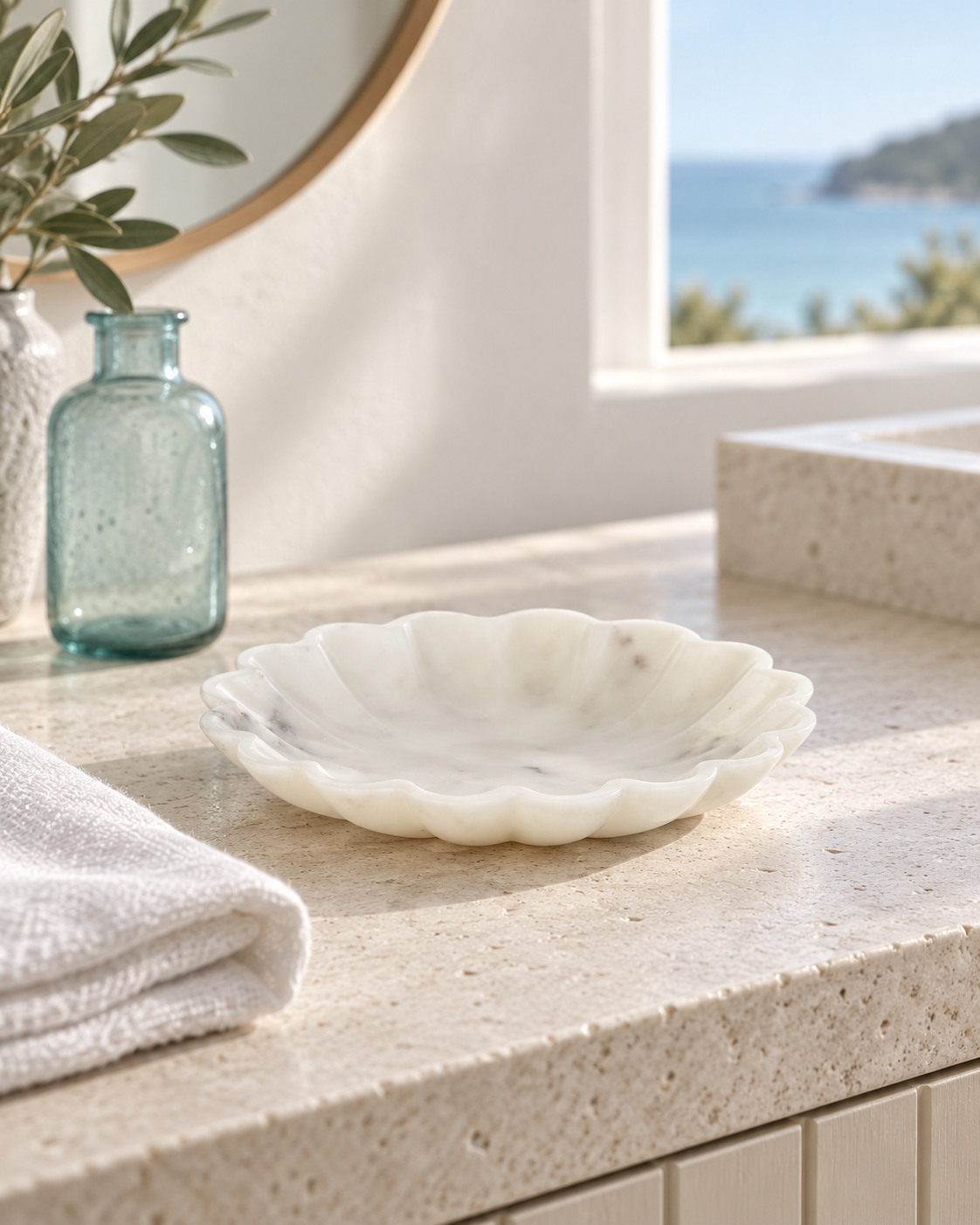 Flora sculpted marble bowl styled in a sunlit coastal interior