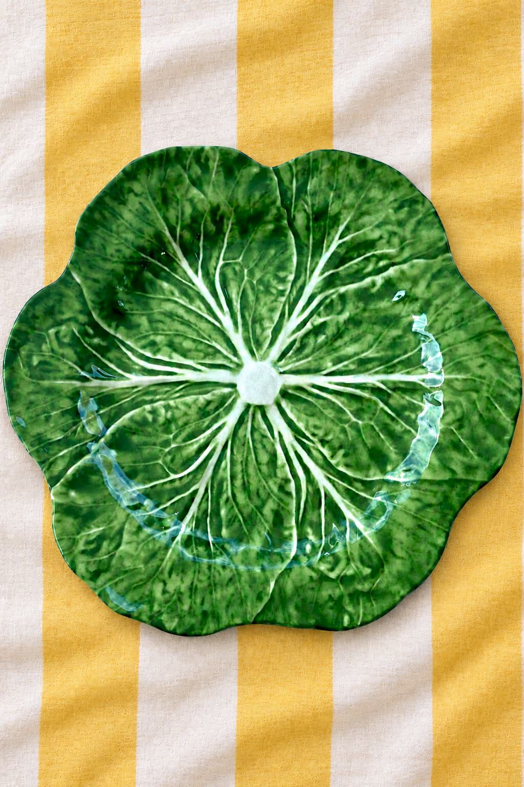 Green Deep Platter – Cabbage Melamine on yellow and white striped tablecloth
