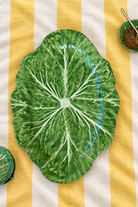 Green XL Oval Platter – Cabbage Melamine on yellow and white striped tablecloth