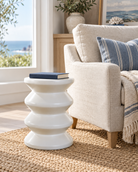 Torano glazed white stool styled in a coastal reading corner