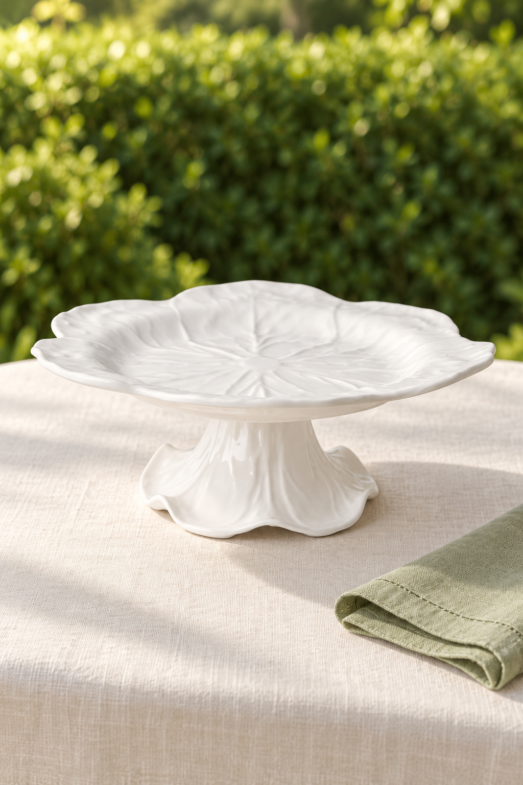 White Cabbage Melamine cake stand, empty, styled outdoors with green linen