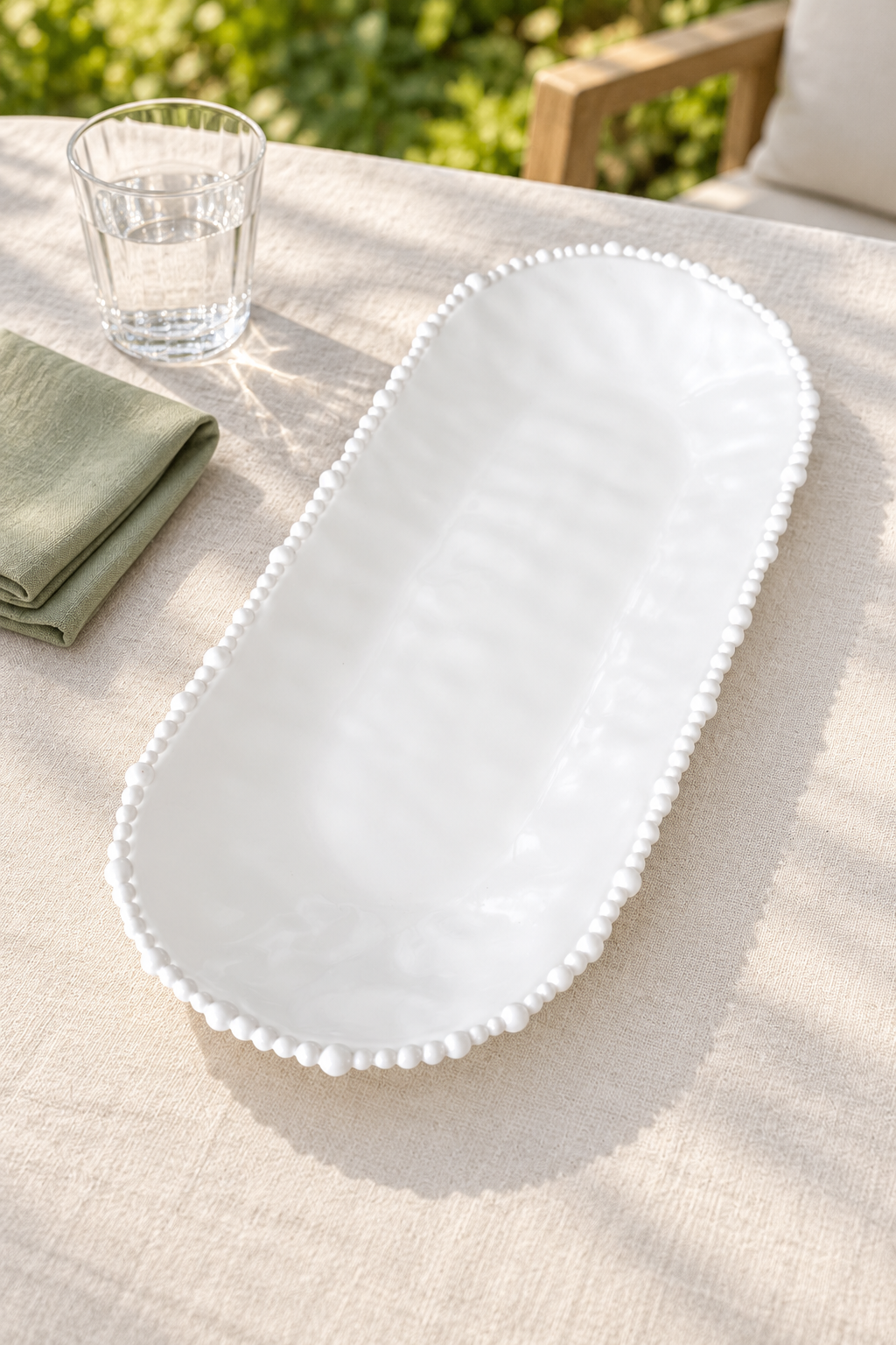White Pearl Melamine long platter styled outdoors with green linen