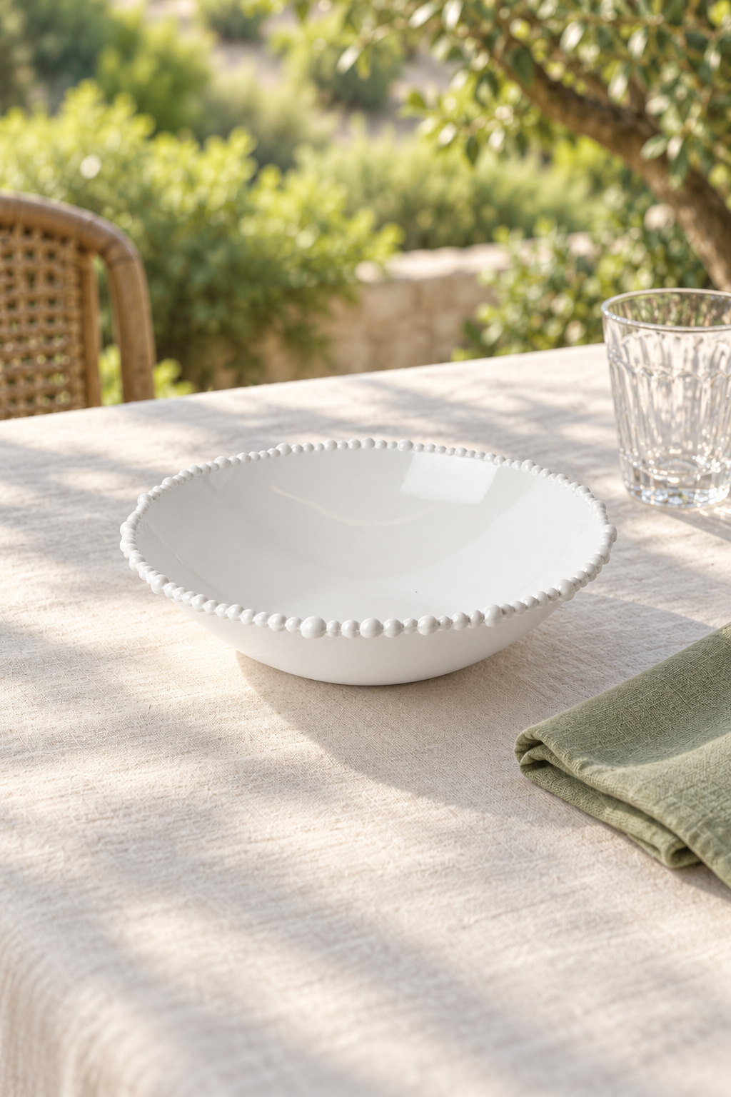 White Pearl Melamine medium tapered bowl styled outdoors with green linen
