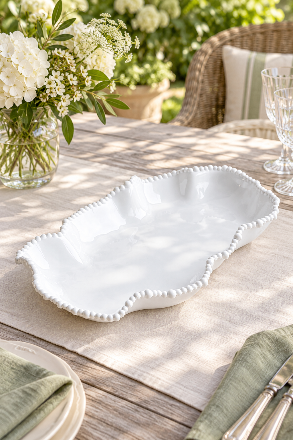 White Pearl Melamine wobbly long dish, empty, styled outdoors with green linen